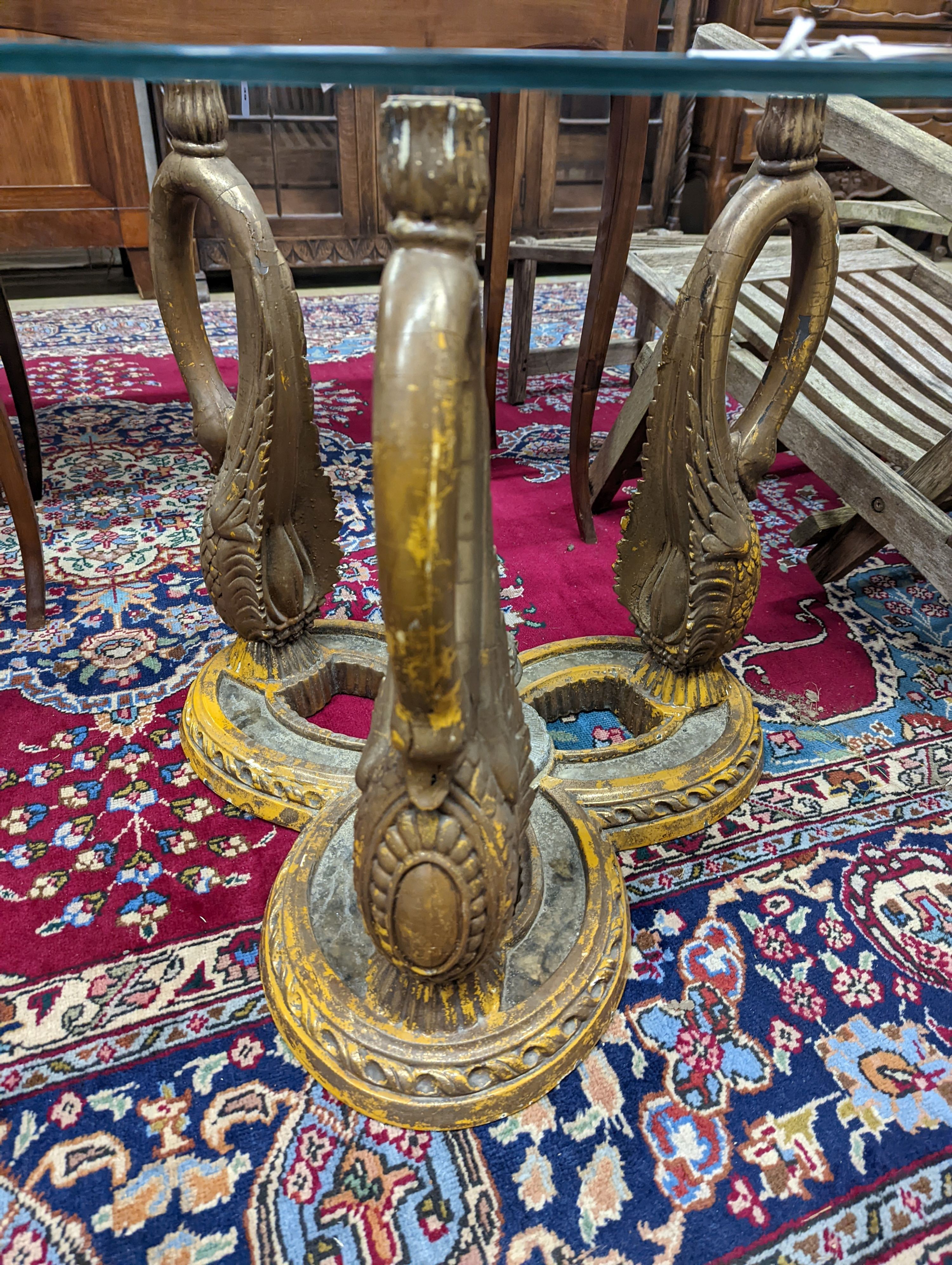 A pair of Empire style circular glass top gilt composition ‘swan’ occasional tables. D-69cm, H-55cm.